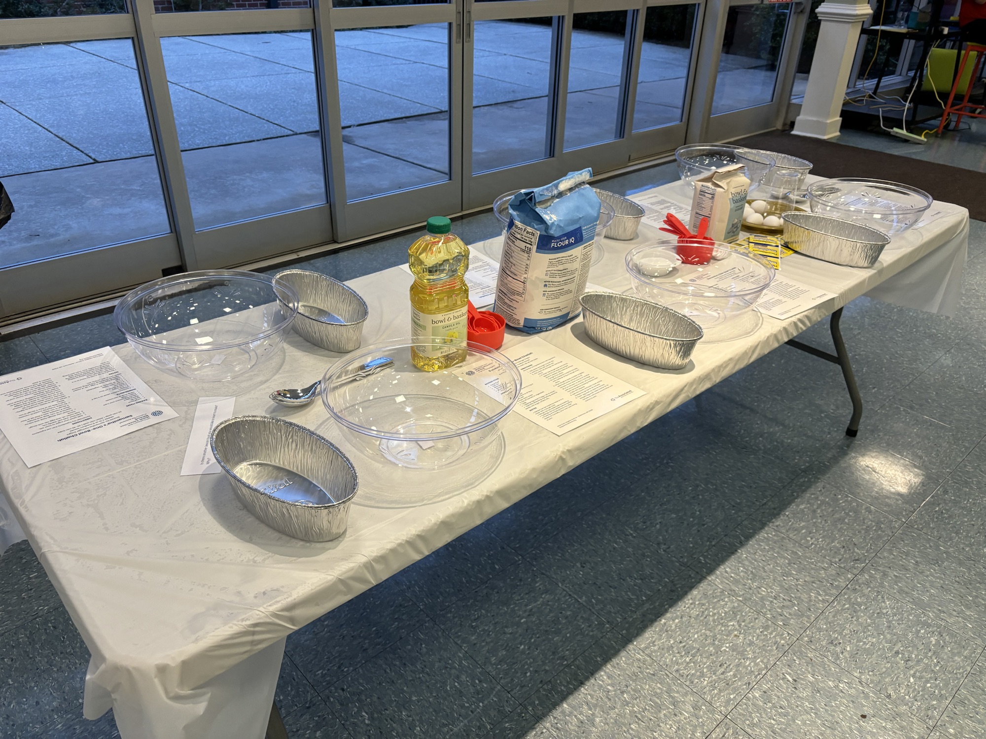 challah making class setup with bowls, tins, and ingredients available for each attendee