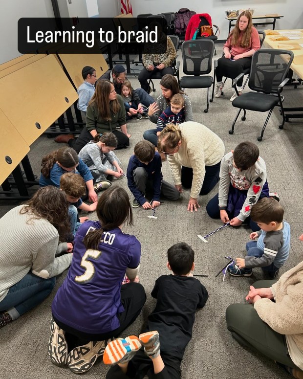 kids learning to braid with pipe cleaners